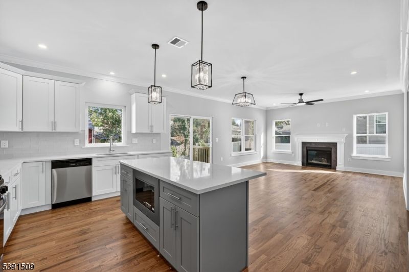 Fireplace, Interior, Kitchen, Pendant Lights, Recessed Lighting, Stainless Steel Appliances, Wood Texture Flooring