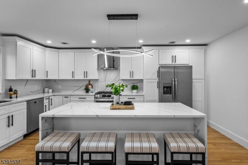 Interior, Kitchen, Marble Walls, Pendant Lights, Recessed Lighting, Stainless Steel Appliances, Wood Texture Flooring