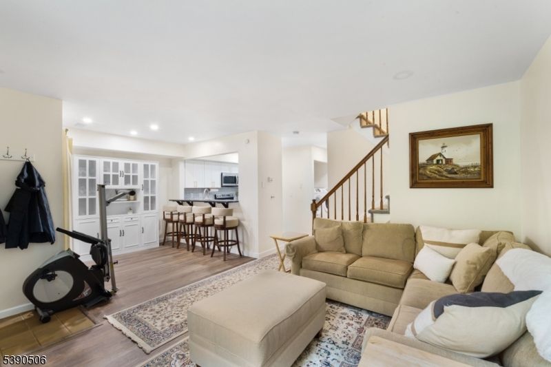 Dining room, Fitness Equipment, Interior, Kitchen, Living room, Recessed Lighting, Stainless Steel Appliances, Wood Texture Flooring