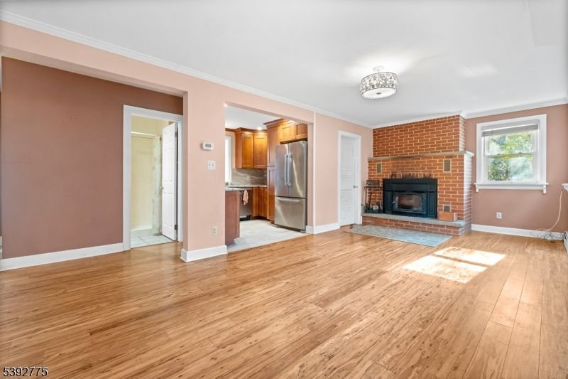 Empty room, Fireplace, Interior, Kitchen, Stainless Steel Appliances, Stone Walls, Wood Texture Flooring