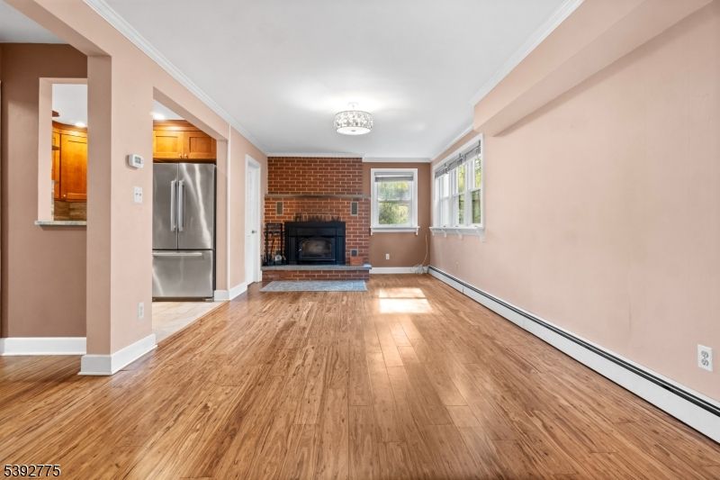 Empty room, Fireplace, Interior, Kitchen, Stainless Steel Appliances, Stone Walls, Wood Texture Flooring