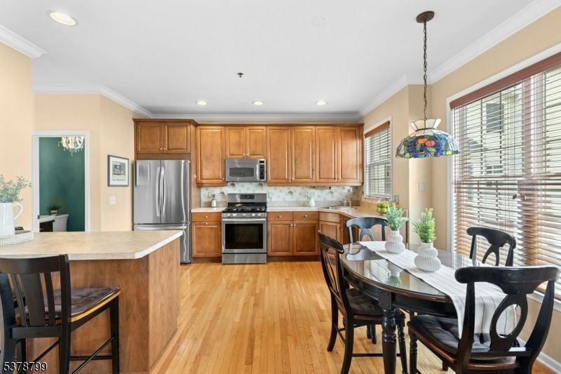 Dining room, Interior, Kitchen, Pendant Lights, Recessed Lighting, Stainless Steel Appliances, Wood Texture Flooring