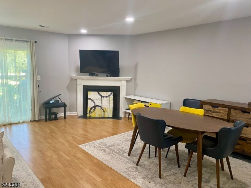 Dining room, Fireplace, Interior, Piano, Recessed Lighting, Wood Texture Flooring