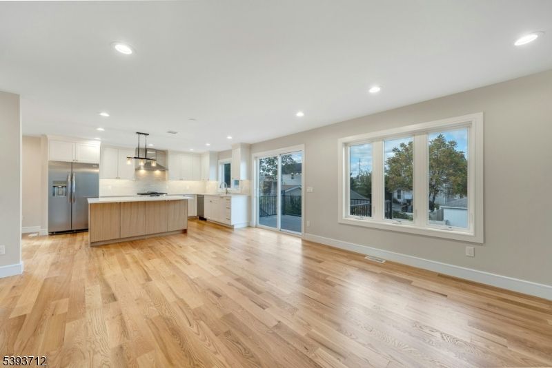 Empty room, Interior, Kitchen, Pendant Lights, Recessed Lighting, Stainless Steel Appliances, Wood Texture Flooring