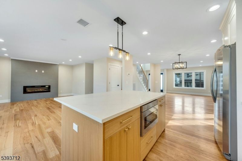 Fireplace, Interior, Kitchen, Pendant Lights, Recessed Lighting, Stainless Steel Appliances, Wood Texture Flooring