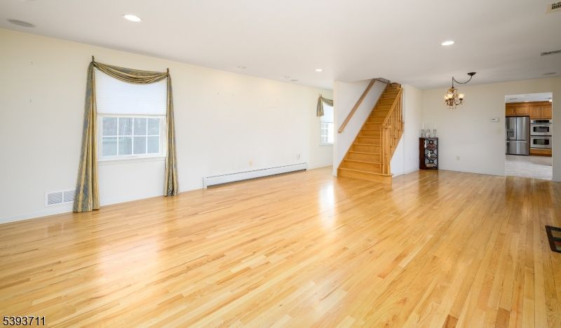 Chandelier, Empty room, Interior, Kitchen, Recessed Lighting, Stainless Steel Appliances, Wood Texture Flooring