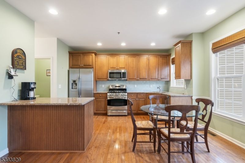 Dining room, Interior, Kitchen, Recessed Lighting, Stainless Steel Appliances, Wood Texture Flooring
