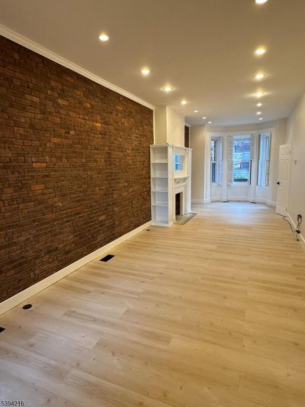 Empty room, Fireplace, Interior, Recessed Lighting, Stone Walls, Wood Texture Flooring