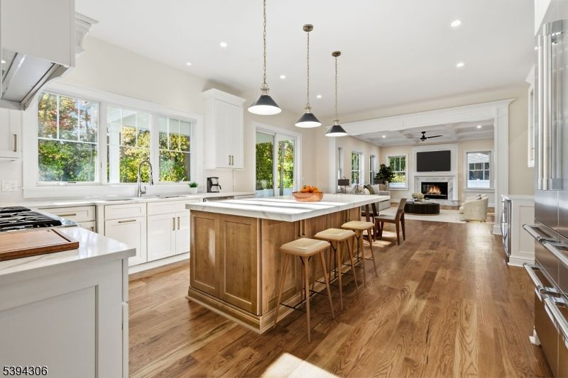 Fireplace, Interior, Kitchen, Living room, Pendant Lights, Recessed Lighting, Stainless Steel Appliances, Wood Texture Flooring