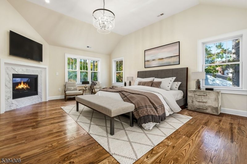 Bedroom, Chandelier, Fireplace, Interior, Recessed Lighting, Wood Texture Flooring
