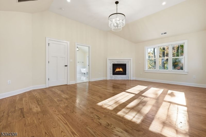 Chandelier, Empty room, Fireplace, Interior, Recessed Lighting, Wood Texture Flooring