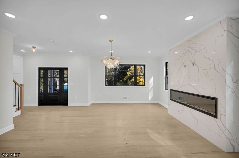 Chandelier, Fireplace, Interior, Marble Walls, Recessed Lighting, Wood Texture Flooring