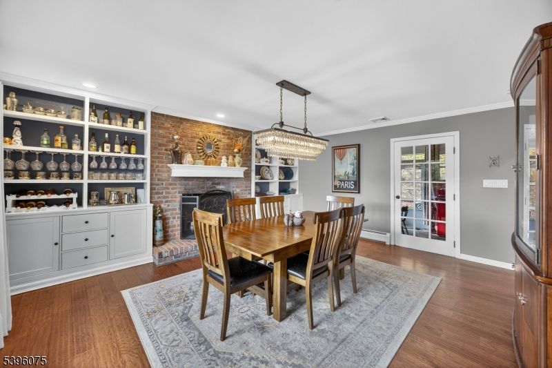 Chandelier, Dining room, Fireplace, Interior, Recessed Lighting, Stone Walls, Wood Texture Flooring