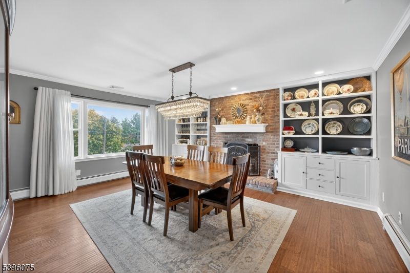 Chandelier, Dining room, Fireplace, Interior, Recessed Lighting, Stone Walls, Wood Texture Flooring