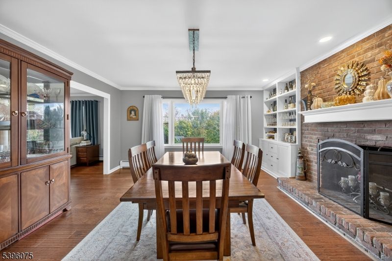 Chandelier, Dining room, Fireplace, Interior, Recessed Lighting, Stone Walls, Wood Texture Flooring