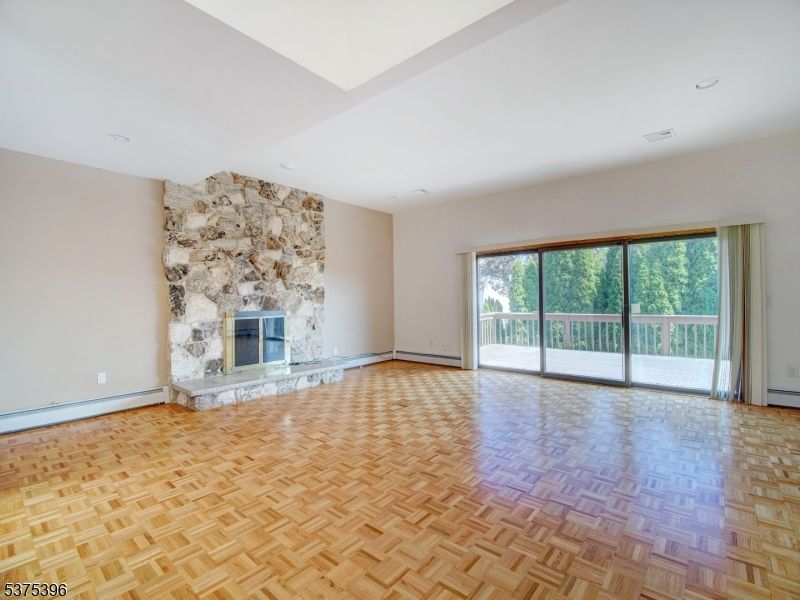 Empty room, Fireplace, Interior, Recessed Lighting, Stone Walls, Wood Texture Flooring