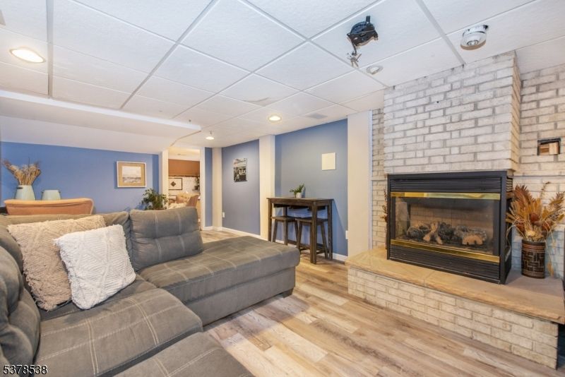 Fireplace, Interior, Living room, Recessed Lighting, Stone Walls, Wood Texture Flooring