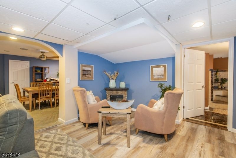 Dining room, Fireplace, Interior, Living room, Recessed Lighting, Wood Texture Flooring