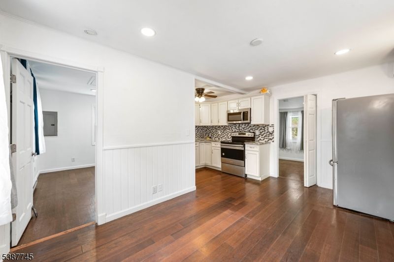 Empty room, Interior, Kitchen, Recessed Lighting, Stainless Steel Appliances, Wood Texture Flooring