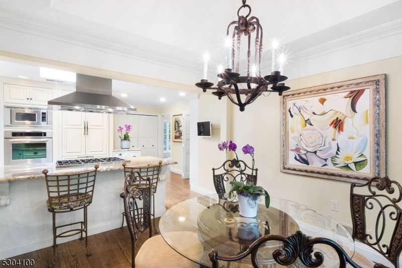 Chandelier, Dining room, Interior, Kitchen, Recessed Lighting, Stainless Steel Appliances, Wood Texture Flooring