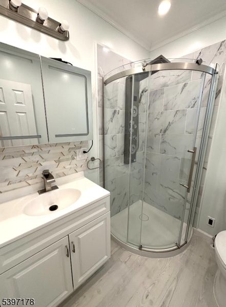 Bathroom, Glass Shower, Interior, Marble Walls, Recessed Lighting, Wood Texture Flooring