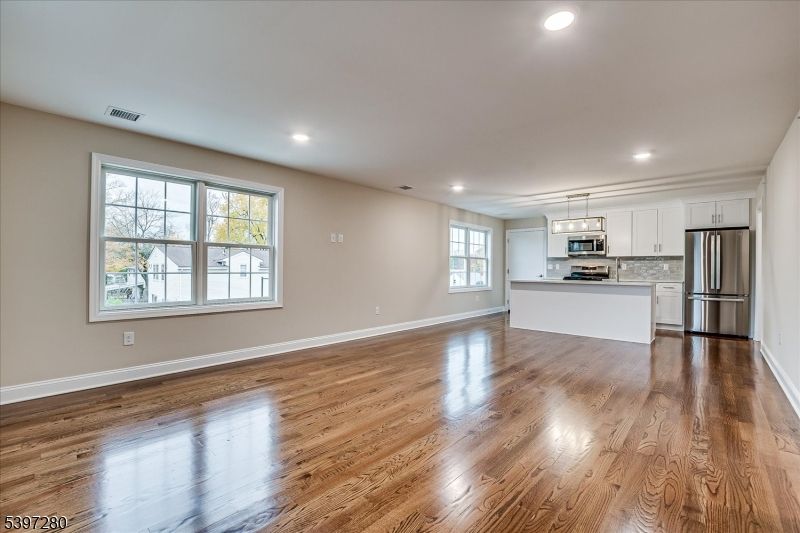 Empty room, Interior, Kitchen, Pendant Lights, Recessed Lighting, Stainless Steel Appliances, Wood Texture Flooring
