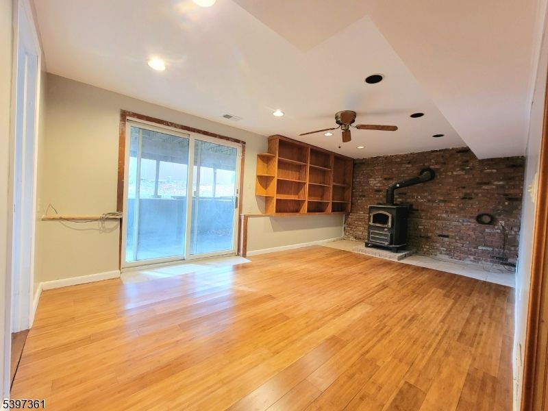 Empty room, Fireplace, Interior, Recessed Lighting, Stone Walls, Wood Texture Flooring