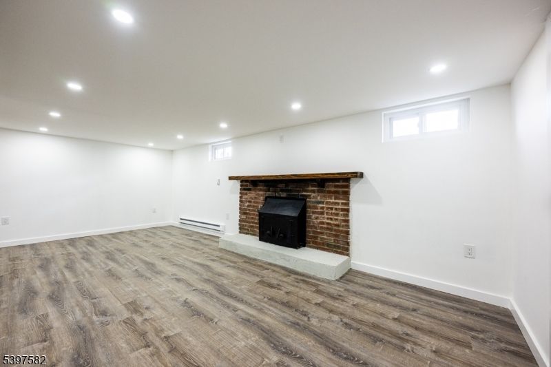 Empty room, Fireplace, Interior, Recessed Lighting, Stone Walls, Wood Texture Flooring