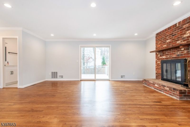 Empty room, Fireplace, Interior, Recessed Lighting, Stone Walls, Wood Texture Flooring