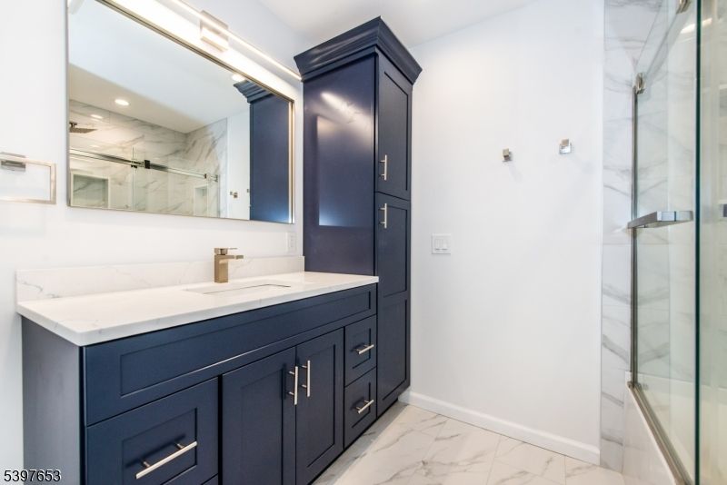 Bathroom, Dual Sink Vanities, Glass Shower, Interior, Marble, Marble Walls, Recessed Lighting