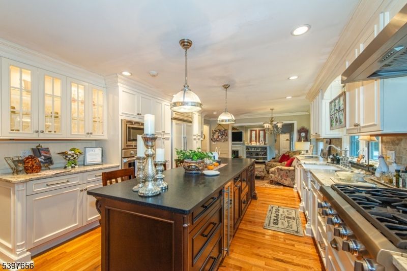 Chandelier, Dining room, Fireplace, Interior, Kitchen, Living room, Pendant Lights, Recessed Lighting, Stainless Steel Appliances, Wood Texture Flooring