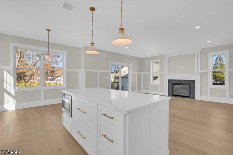 Empty room, Fireplace, Interior, Kitchen, Pendant Lights, Recessed Lighting, Wood Texture Flooring