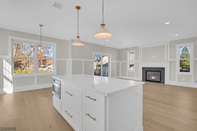 Empty room, Fireplace, Interior, Kitchen, Pendant Lights, Recessed Lighting, Wood Texture Flooring