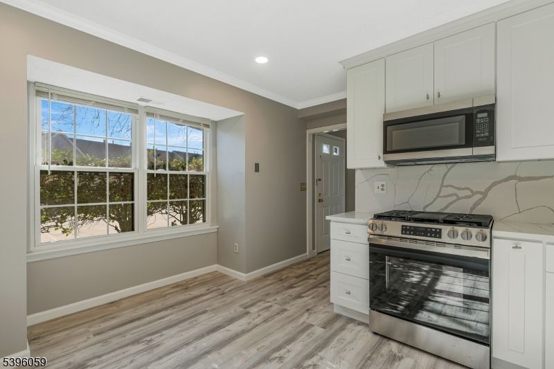 Interior, Kitchen, Marble Walls, Recessed Lighting, Stainless Steel Appliances, Wood Texture Flooring