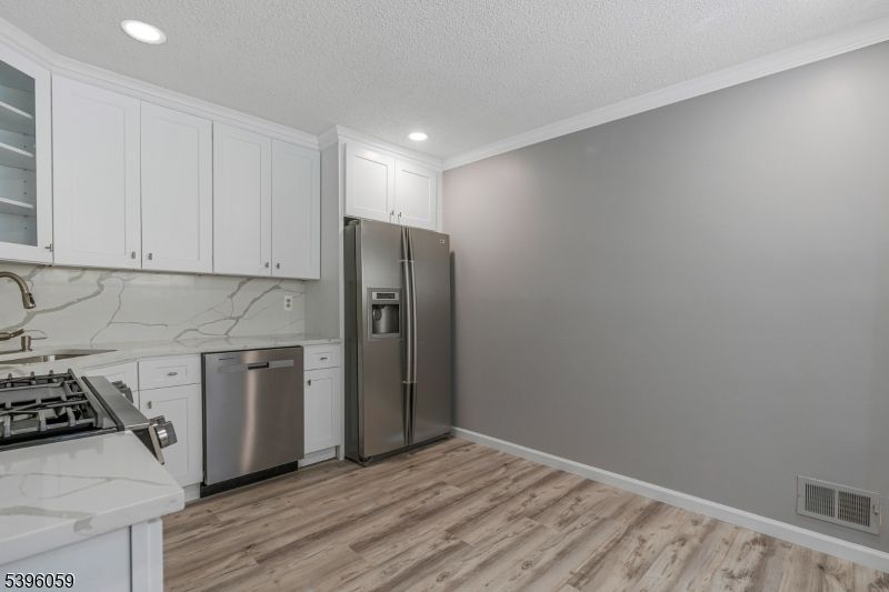 Interior, Kitchen, Marble Walls, Recessed Lighting, Stainless Steel Appliances, Wood Texture Flooring