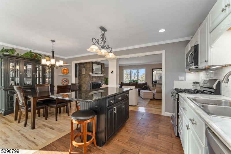 Chandelier, Dining room, Fireplace, Interior, Kitchen, Living room, Recessed Lighting, Wood Texture Flooring
