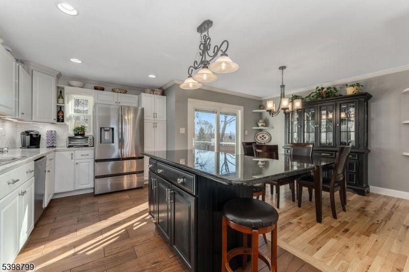 Chandelier, Dining room, Interior, Kitchen, Pendant Lights, Recessed Lighting, Stainless Steel Appliances, Wood Texture Flooring