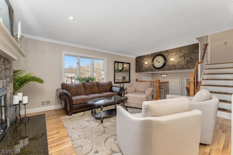 Fireplace, Interior, Living room, Recessed Lighting, Stone Walls, Wood Texture Flooring