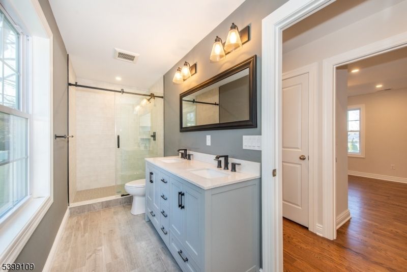 Bathroom, Dual Sink Vanities, Glass Shower, Interior, Recessed Lighting, Wood Texture Flooring