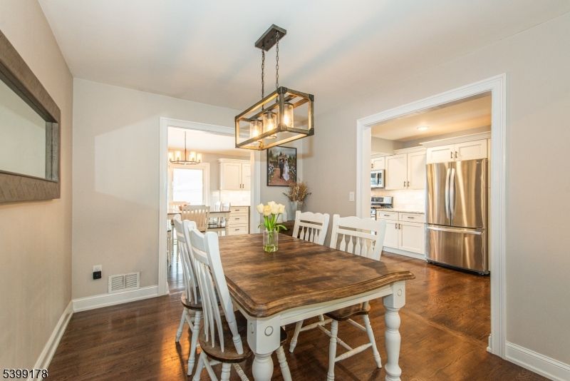 Chandelier, Dining room, Interior, Kitchen, Pendant Lights, Recessed Lighting, Stainless Steel Appliances, Wood Texture Flooring