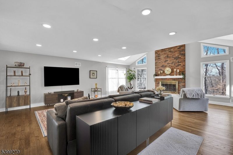 Fireplace, Interior, Living room, Recessed Lighting, Stone Walls, Wood Texture Flooring