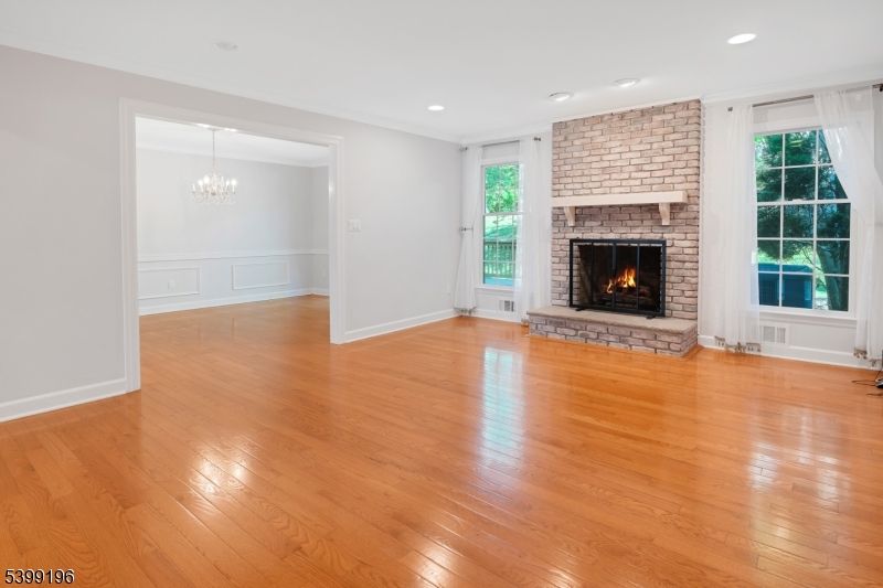 Chandelier, Empty room, Fireplace, Interior, Recessed Lighting, Stone Walls, Wood Texture Flooring