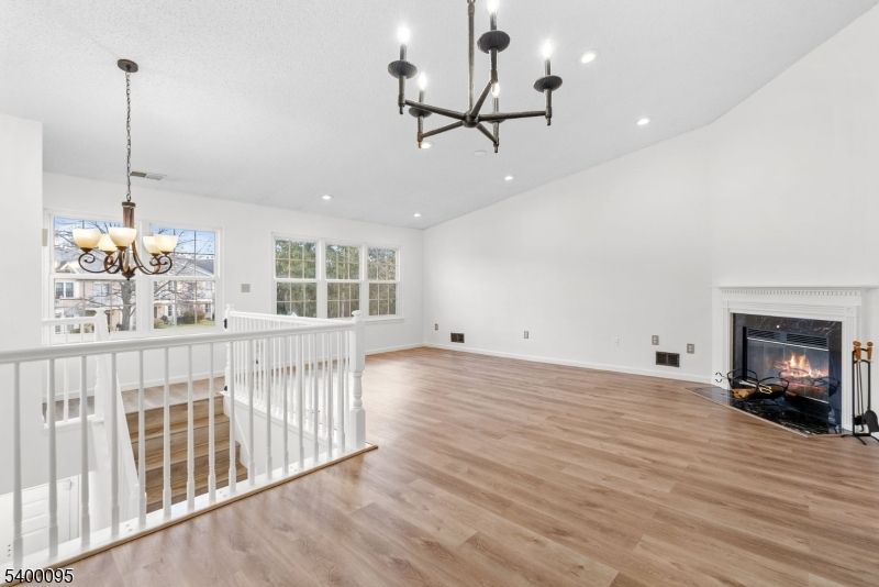 Chandelier, Empty room, Fireplace, Interior, Recessed Lighting, Wood Texture Flooring