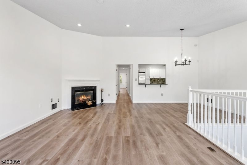 Chandelier, Empty room, Fireplace, Interior, Pendant Lights, Recessed Lighting, Wood Texture Flooring