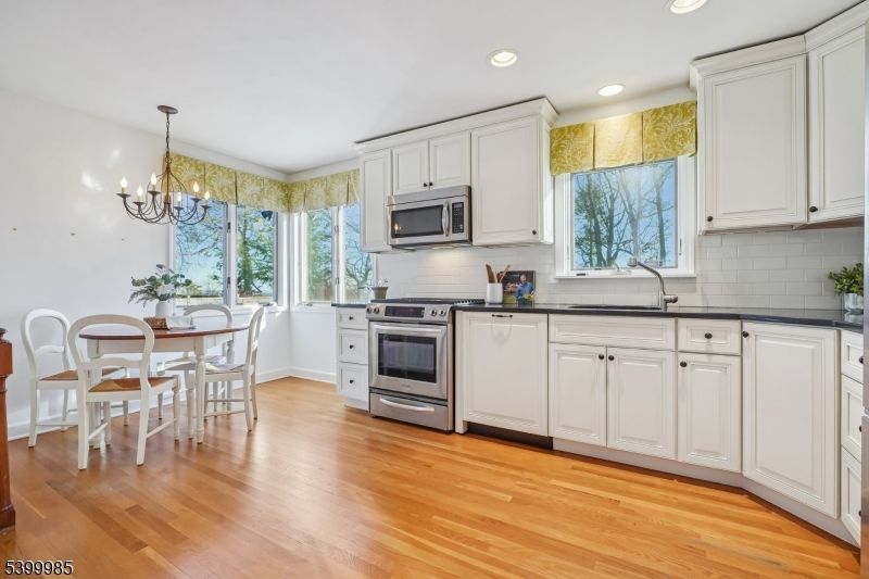 Chandelier, Dining room, Interior, Kitchen, Recessed Lighting, Stainless Steel Appliances, Wood Texture Flooring