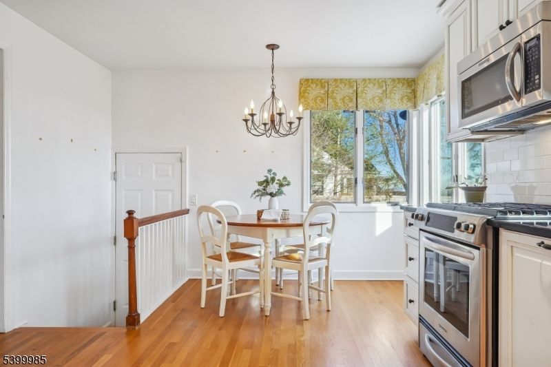 Chandelier, Dining room, Interior, Kitchen, Stainless Steel Appliances, Wood Texture Flooring