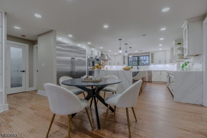 Dining room, Interior, Kitchen, Marble Walls, Pendant Lights, Recessed Lighting, Stainless Steel Appliances, Wood Texture Flooring