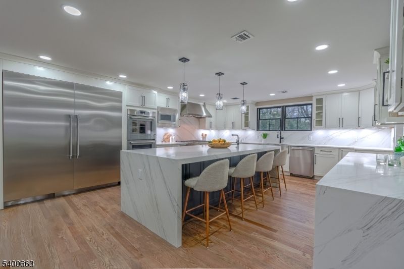 Interior, Kitchen, Marble Walls, Pendant Lights, Recessed Lighting, Stainless Steel Appliances, Wood Texture Flooring