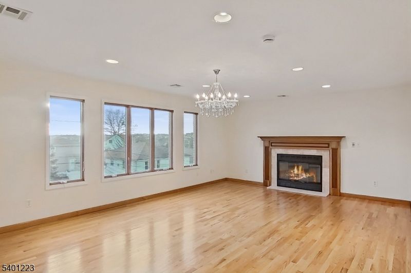 Chandelier, Empty room, Fireplace, Interior, Recessed Lighting, Wood Texture Flooring