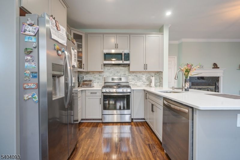 Fireplace, Interior, Kitchen, Recessed Lighting, Stainless Steel Appliances, Wood Texture Flooring